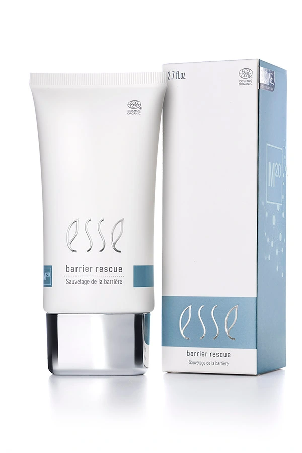 A white tube labeled “Esse Barrier Rescue” stands beside its matching blue and white box packaging on a white background, both featuring the Esse logo and product name in clean, modern fonts.